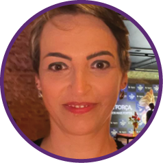 a woman with short hair and a purple shirt