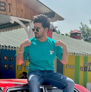 a man sitting on top of a car