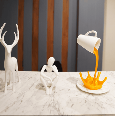 a person pouring orange juice into a cupcake