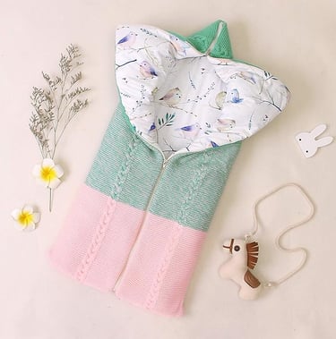 Knitted shell baby sleeping bag with cotton liner. Zipper access to open and convert to a baby blanket.