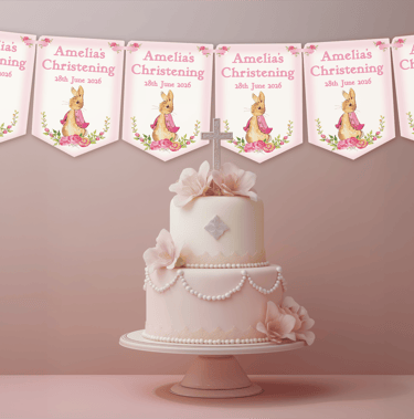 Personalised pink rabbit christening bunting displayed above an elegant pink baptism cake table