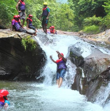 Sliding down a water fall wearing PPE is thrilling and fun