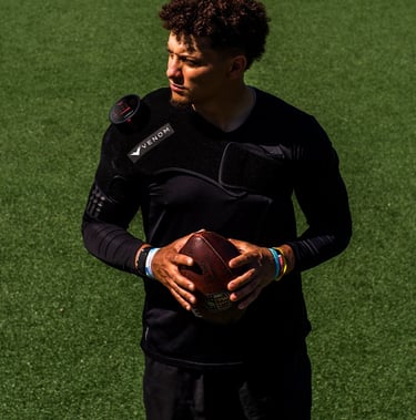 Patrick Mahomes holding a football ball with venom heat hyperice treatment 