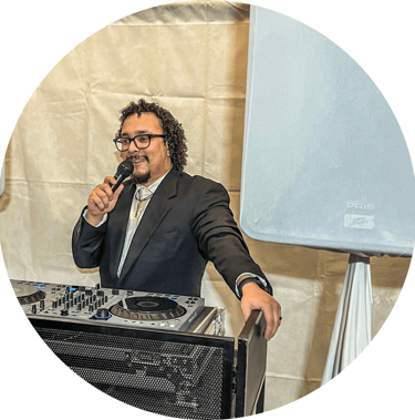 a man in a suit and tie is holding a microphone