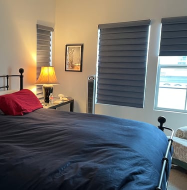 a bed with a red and black bedding