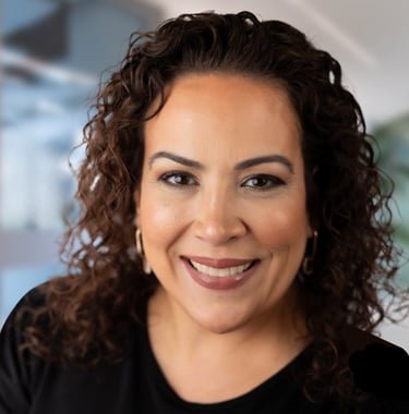 a woman with curly hair and a black shirt