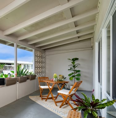 After staging: an unclutered patio with a table and chairs and a couch