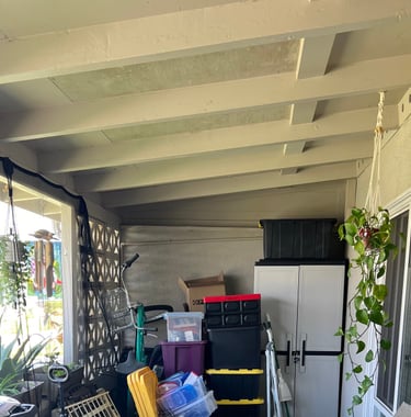 Before staging: a cluttered patio with a table and chairs and a table