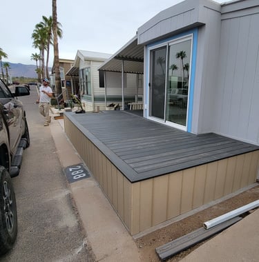 Best Handyman Tucson - A modern grey mobile home with a newly installed dark composite deck