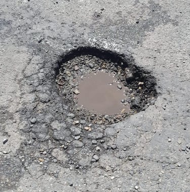 Pothole that needs repaired on parking lot job