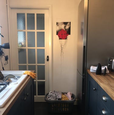 image of nude woman with censored face curated in a domestic kitchen space