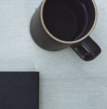 journal, journal sleeve and cup of coffee
