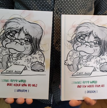 a person holding two cards with a drawing of a girl