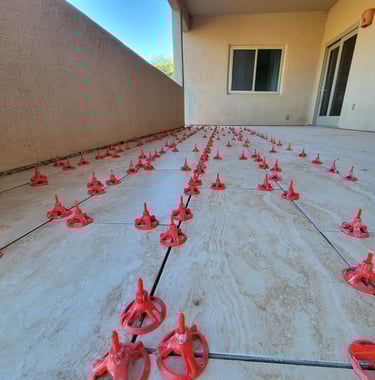 Best Handyman Tucson - Red tile leveling system spacers installed on a patio 