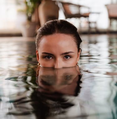 Women in pool with reflections from the water