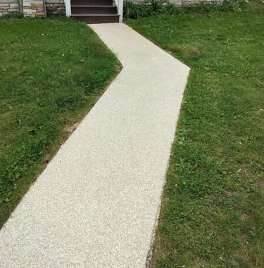 Resurfaced concrete walkway with a light textured finish leading to a front porch, enhancing curb