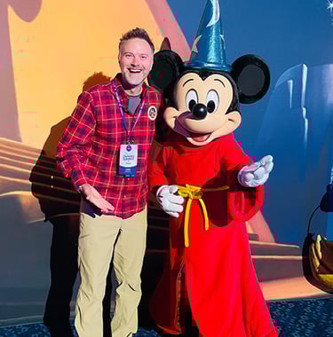 Chris Breedlove pictured with Mickey Mouse at the Disneyland® Hotel.