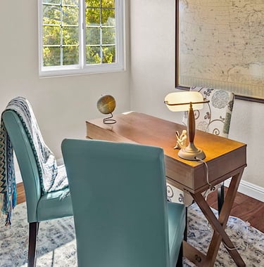 After staging: a desk with a desk and chair in a room