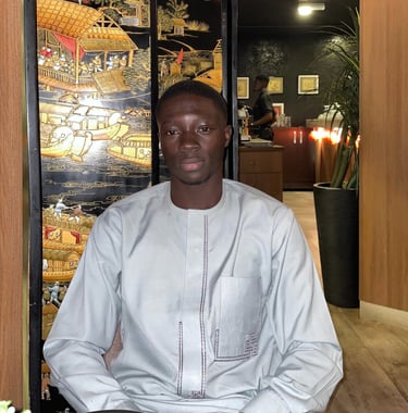 a man sitting at a table with a laptop