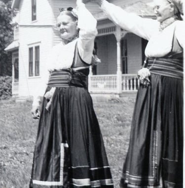 two women in bunad dancing, black and white