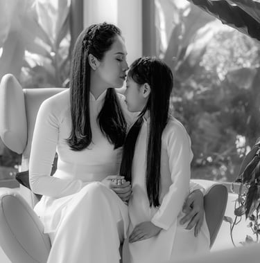 a mother and daughter kissing in a living room