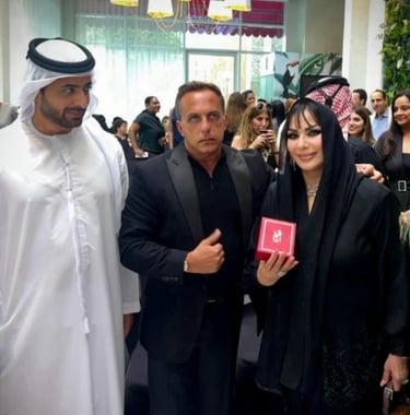 A group of people stand together at a Bedig Minassian event, with some holding phones to take photos