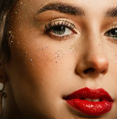 Zoomed in up close facial photo of female with green eyes and red lipstick. Very retouch skin