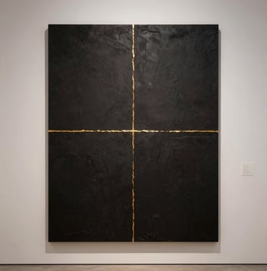 Photography of a minimalist, contemporary art installation in a high-end Dubai gallery. The composition is clean with lots of negative space, featuring dark textures and a single thin line of gold leaf. Soft, sophisticated lighting.