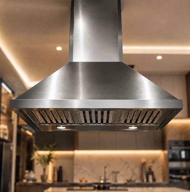 A modern stainless steel wall mount range hood with baffle filters in a luxury kitchen.