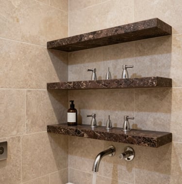 A detailed shot of a premium bathroom finish. Light stone beige tiles cover the walls, accented by dark espresso brown stone shelves. The fixtures are high-end, and the overall mood is that of a private spa in a luxury Egyptian villa.