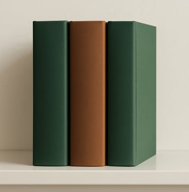 A row of three academic textbooks standing on a clean shelf. The covers use a palette of Forest Green and Wood Brown with elegant serif typography. Clean, bright North American interior lighting.