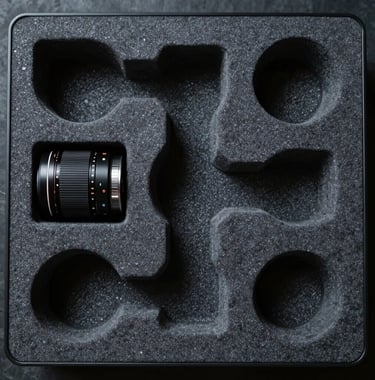 A top-down view of a technical assembly kit in a specialized foam insert. North American / US industrial design. Deep Charcoal and Cool Grey.