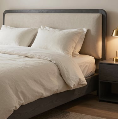 A luxury bedroom suite with layered off-white textures, charcoal gray wood accents, and soft gold bedside lighting, exuding warmth and tranquility. International / High-end.
