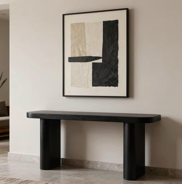 A stylish foyer in a luxury apartment in Bhopal, showcasing a minimalist matte black console table and a piece of contemporary art against an ivory wall.