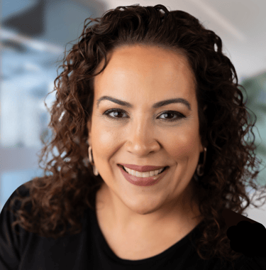 a woman with curly hair and a black shirt