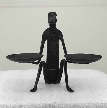 "Handcrafted tribal iron art-seated man holding oil lamps-front view-for international trade"