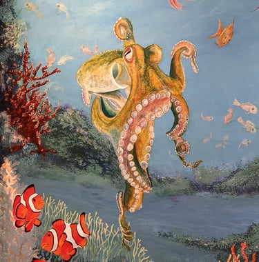 A bathroom wall mural featuring coral reef, clown fish, octopus, small fish and Anemone.