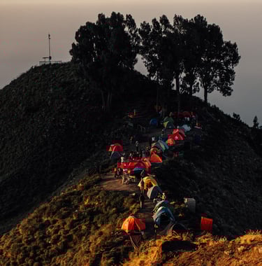 a group of people are gathered around a mountain