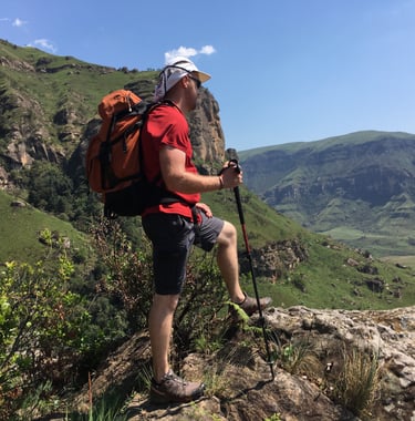 a man with a backpack on a mountain