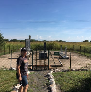 a woman in a hat at a Boer War grave site