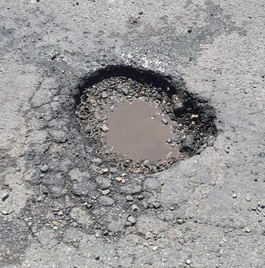 Pothole that needs repaired on parking lot job