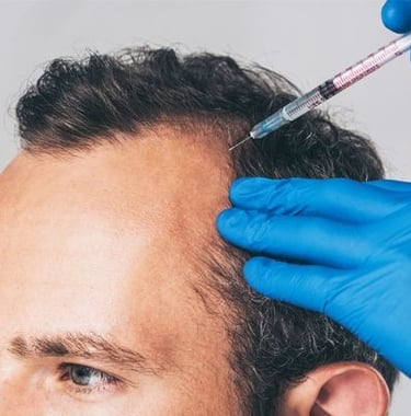 man receiving laser hair restoration