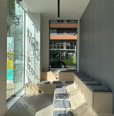 Stadium seating made of play. Grey slat feature wall. Stencil on glass