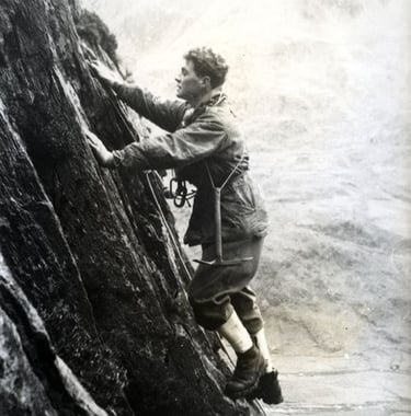 a pioneer of alpinism climbing a rock cliff