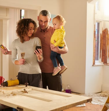 family of three inside a house that's being built