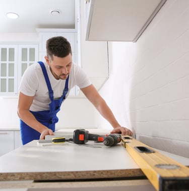 man using tools to measure a counter
