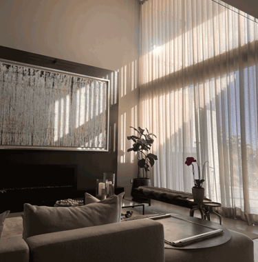 Sala iluminada naturalmente con ventanales altos y mobiliario elegante | KARÄNA