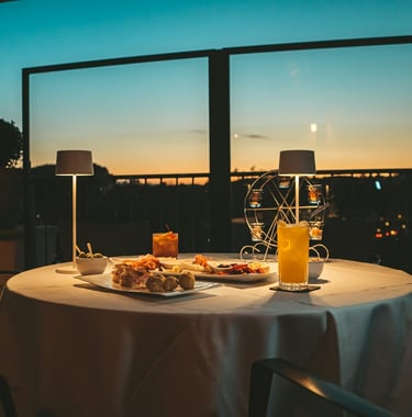 Romantic sunset terrace dining, European cuisine, elegant outdoor restaurant ambiance