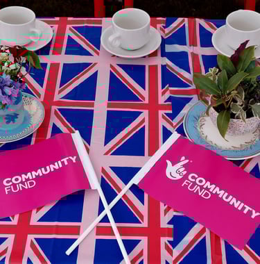 a table with a table cloth with flags and flags community fund
