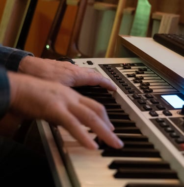 Luke Stidworthy playing keyboard at Vox Music Recording Studio in South Manchester